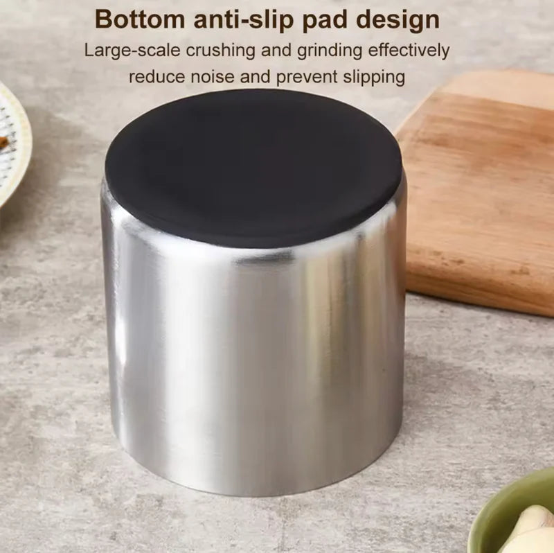 Stainless steel container with black lid on a gray surface, featuring text about anti-slip design.