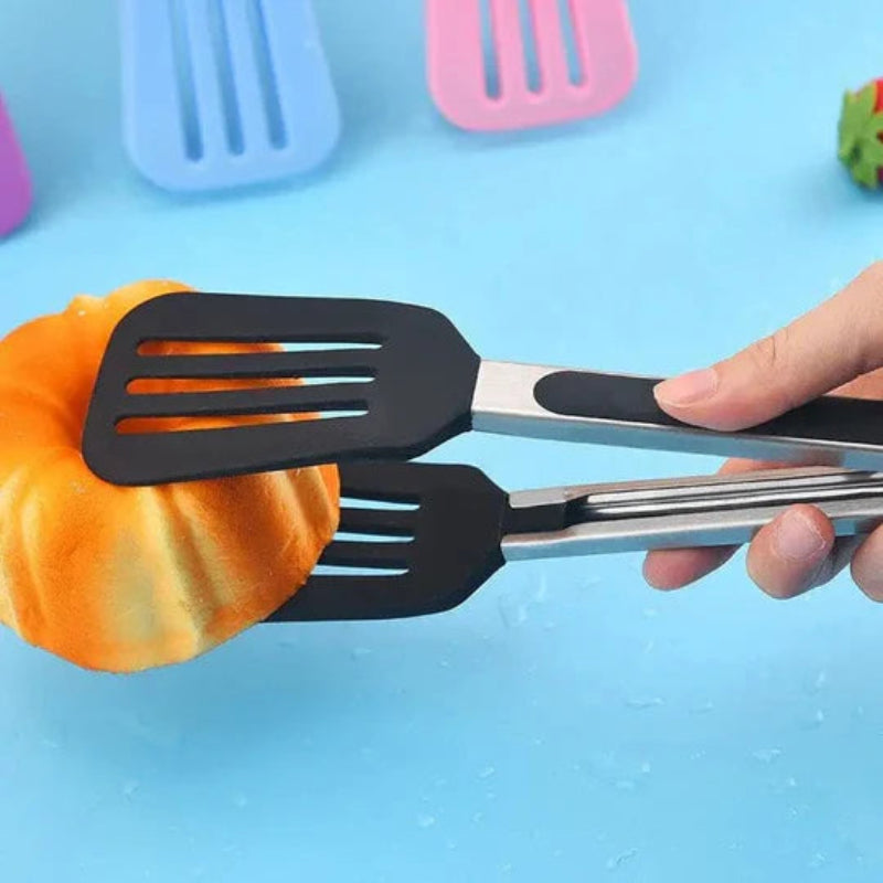 Black and silver spatula held over a colorful object on a blue background