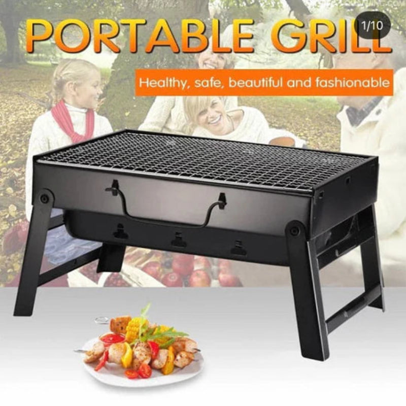 Portable grill with a plate of food on a white surface, with people in the background.