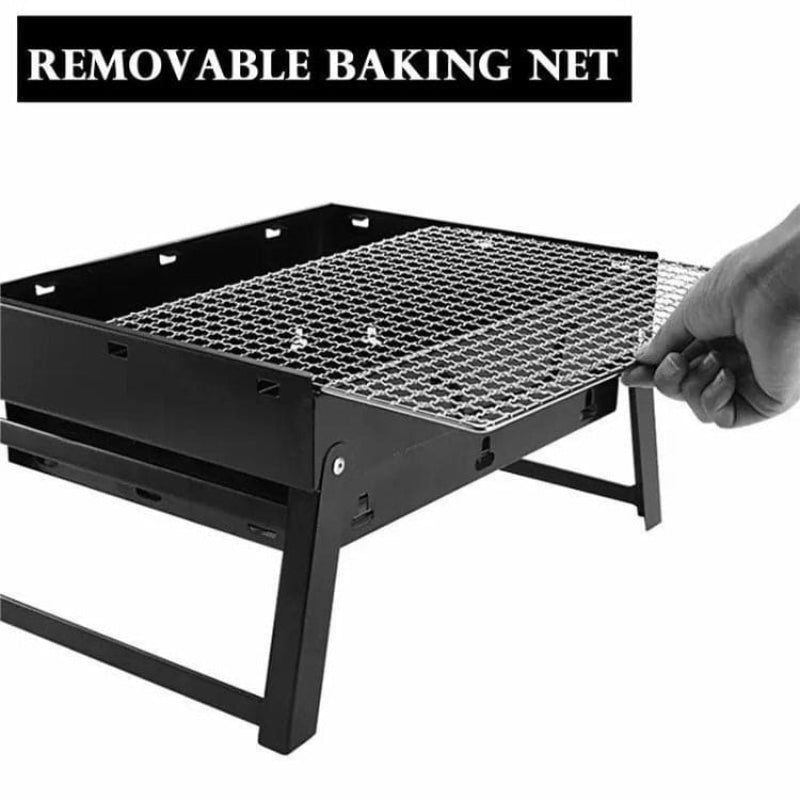 Black portable grill with a removable baking net on a white background